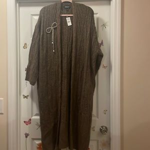 Women’s sweater duster with rhinestone accent.